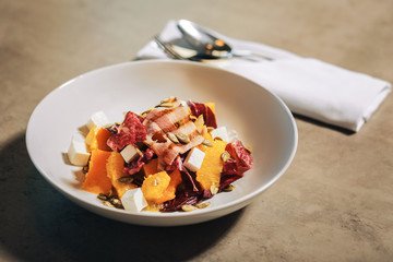 Tasty healthy salad bowl with feta cheese and bacon