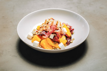 Top view of healthy nourishing salad with bacon and feta cheese