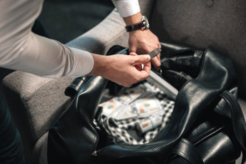 Criminal holding little memory stick while running away from crime site