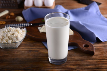 Glass of milk on wooden table
