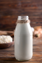 Bottle of milk on wooden table