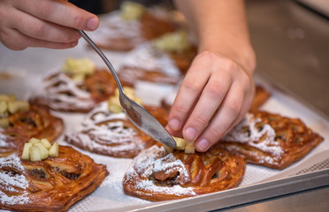 Cheef's hands decorating cake