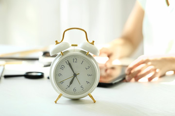 Alarm clock on white table in office
