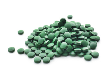 Spirulina tablets on white background