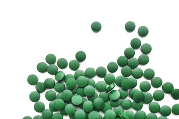 Spirulina tablets on white background