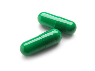 Spirulina capsules on white background