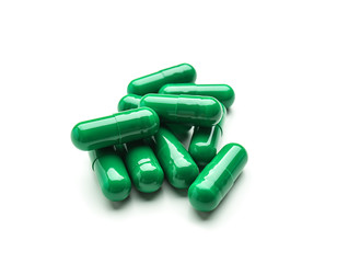 Spirulina capsules on white background
