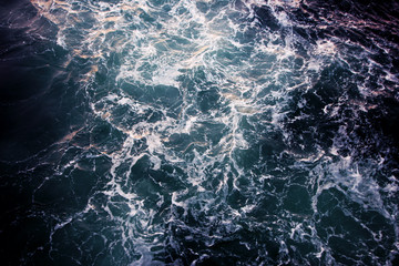 Ocean view from the top. Blue-green waves, storm, sea surface.