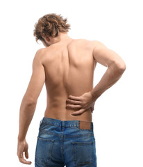 Young man suffering from back pain on white background