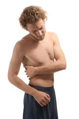 Young man suffering from back pain on white background