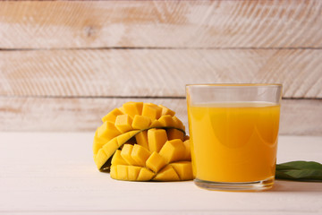 mango juice in a glass and mango fruit.