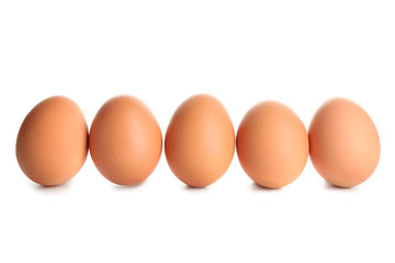 Raw brown chicken eggs on white background