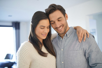 Fototapeta premium Portrait of gorgeous couple embracing at home