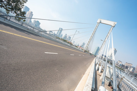 empty asphalt road with city skyline