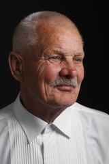 Fototapeta premium Pensive senior in white shirt