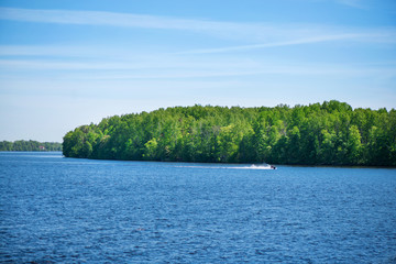Young people on jet ski. Water splash all around. Concept of speed, competition and having fun during summer vacation by the water. 