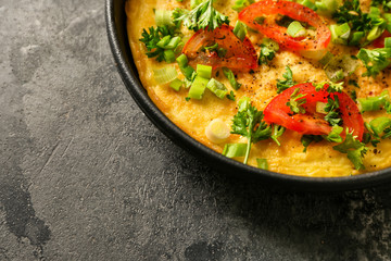 Fototapeta na wymiar Pan with tasty omelet on grey table, closeup