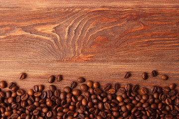 coffee beans on wood background. Aromatic coffee, coffee drinks
