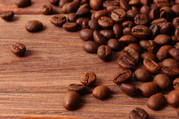 coffee beans on wood background. Aromatic coffee, coffee drinks