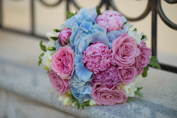 bridal bouquet on the background of a wrought-iron fence