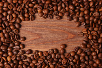 coffee beans on wood background. Aromatic coffee, coffee drinks