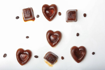 Composition with coffee ice pieces on white background