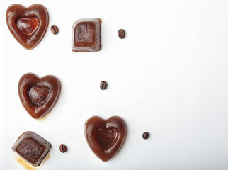 Composition with coffee ice pieces on white background