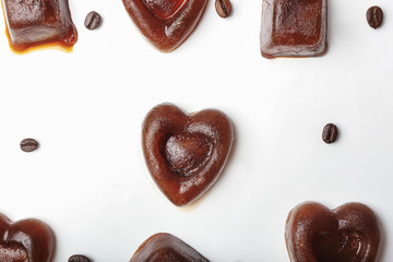 Composition with coffee ice pieces on white background