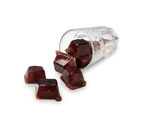 Overturned glass with coffee ice cubes on white background