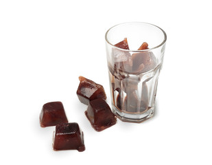 Glass with coffee ice cubes on white background