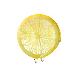 Essential oil dripping from lemon slice on white background