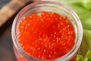 Jar with delicious red caviar, closeup