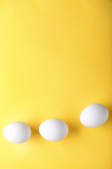 Raw chicken eggs on color background