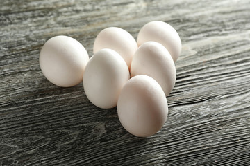 Raw chicken eggs on wooden background