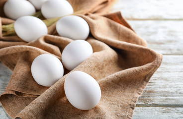Raw chicken eggs on wooden table