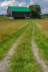 rural road in the countryside leading to old barn