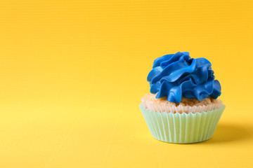 Tasty cupcake on color background