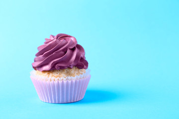 Tasty cupcake on color background