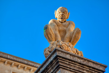 architecture details of San Marino , devil statue on the column
