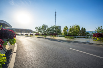 empty asphalt road with city skyline