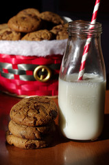 Christmas cookies in basket with milk and red paper straw  