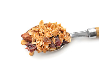 Spoon with granola on white background