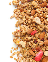 Granola with dried fruits and nuts on white background