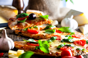 Pizza on wood with ingredients