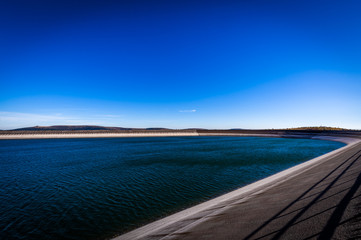 Scenic photo of the upper water reservoire Dlouhe Strane in the Jeseniky mountains in Czech Republic with dark blue sky and waves on the water