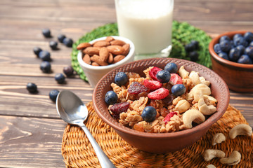 Granola with dried fruits and nuts in bowl on table