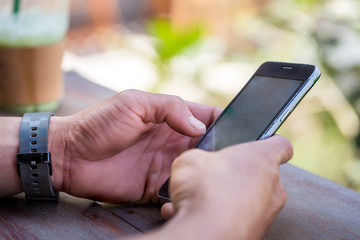 Young man's hands using smartphone