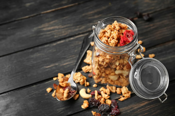 Granola in jar on dark wooden table