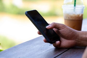 Man's hand using smart phone