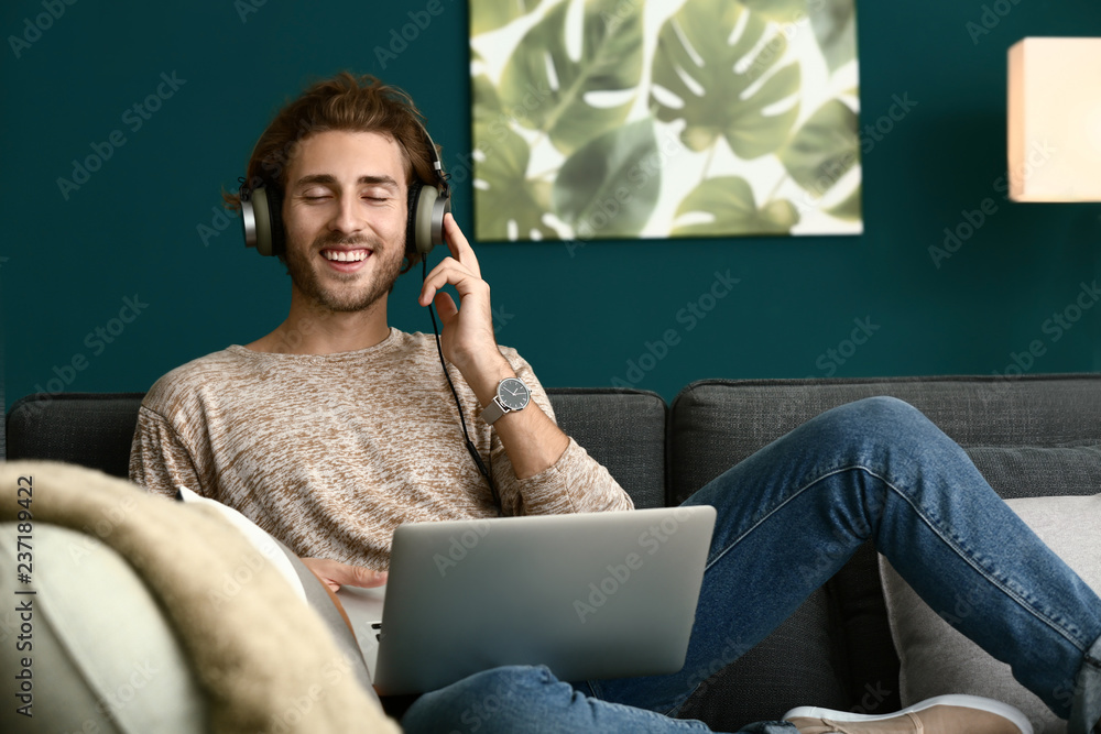 Canvas Prints Young man listening to music at home